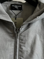 Light gray hooded jacket with front zipper and zipper pull hardware