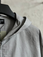 Light gray jacket shoulder seam with hood edge and collar