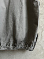 Light gray hooded jacket side view with elastic hem detail