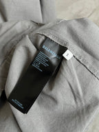 Light gray hooded jacket neckline with inner tag and stitched seam