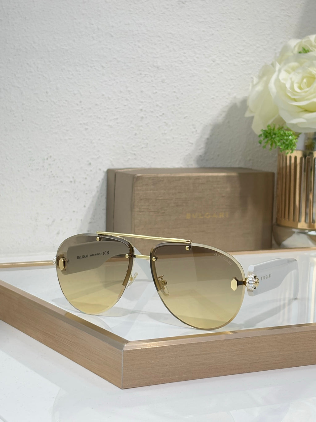Gold-tone sunglasses with pale yellow gradient lenses and jeweled side detail