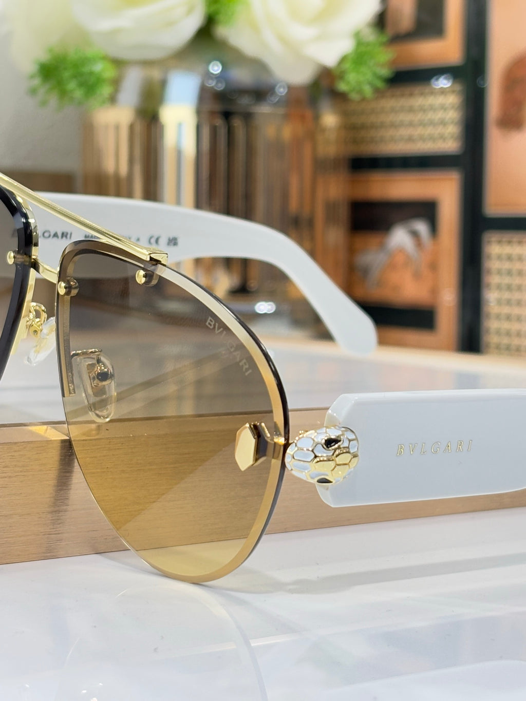 Gold-tone sunglasses with clear temple tips and gradient lenses