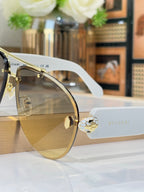 Gold-tone sunglasses with clear temple tips and gradient lenses