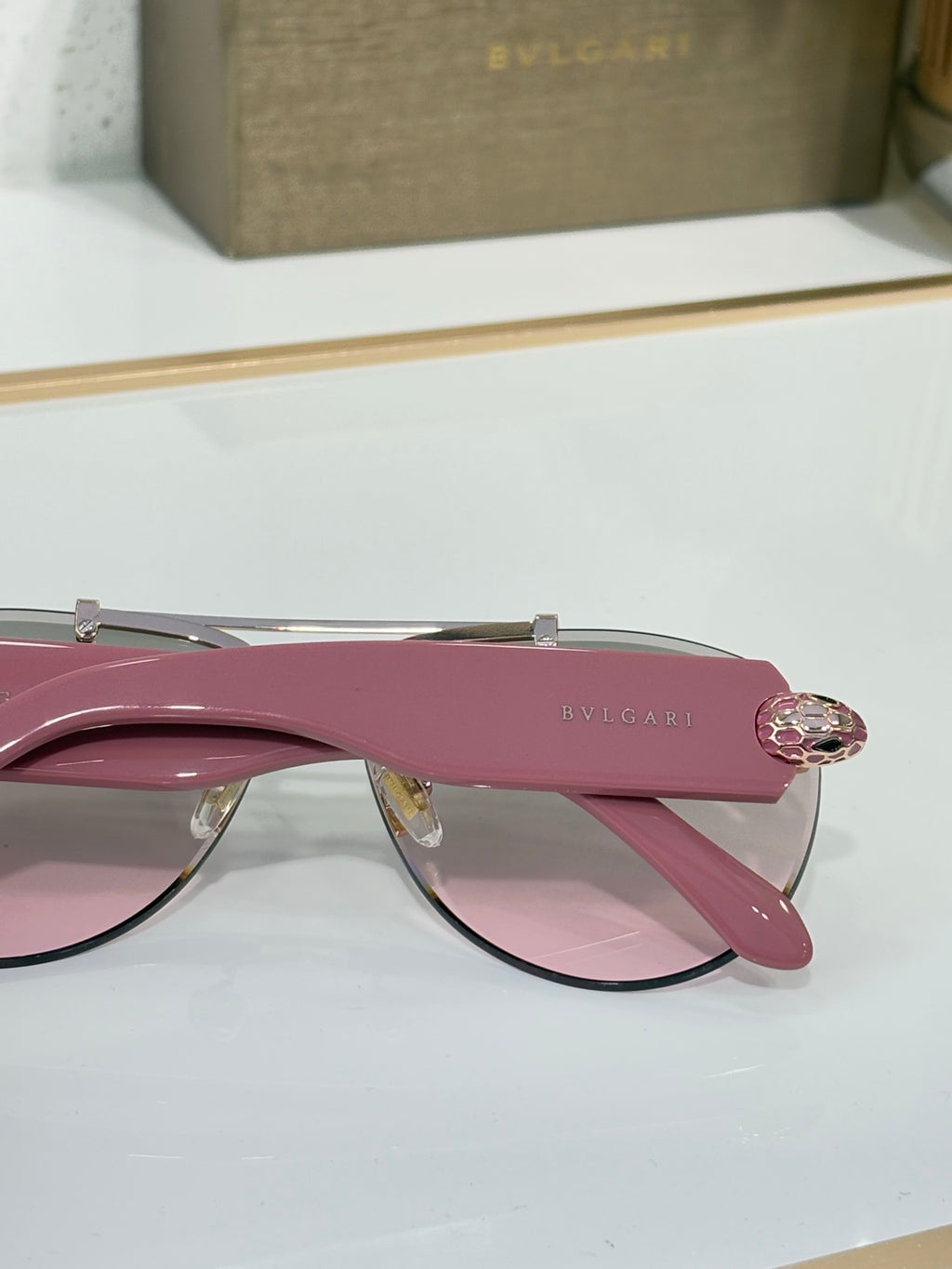 Pink sunglasses with rose-pink gradient lenses and gold-tone top bar