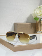 Dark metal sunglasses with golden-tinted lenses and gold-tone accents