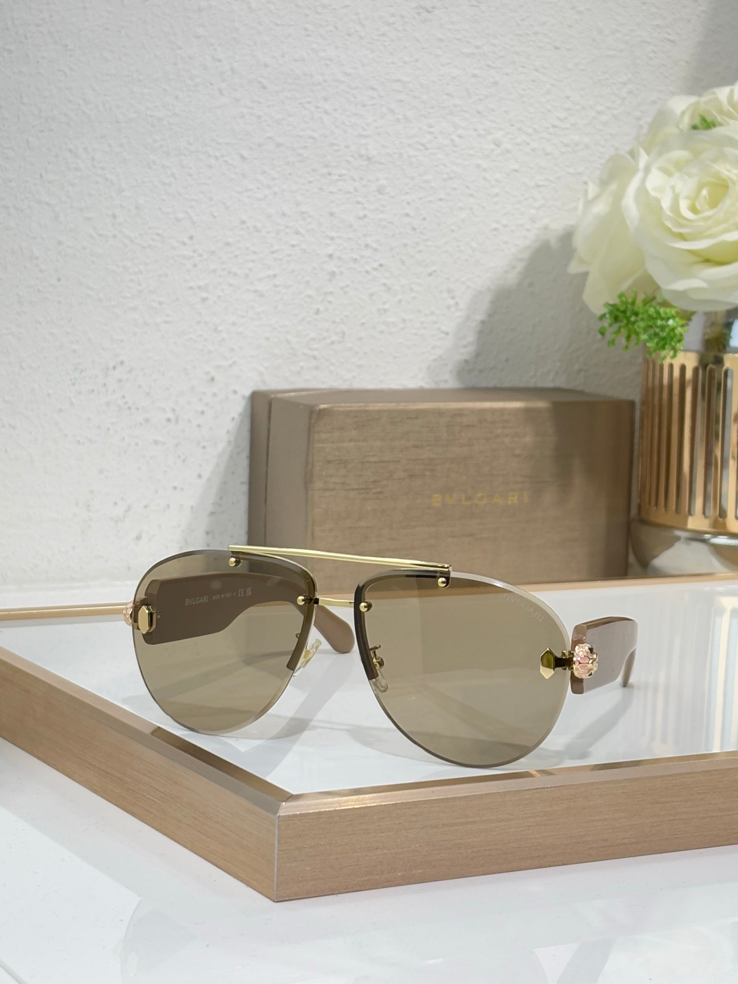 Gold-tone sunglasses with light yellow gradient lenses and decorative front charm