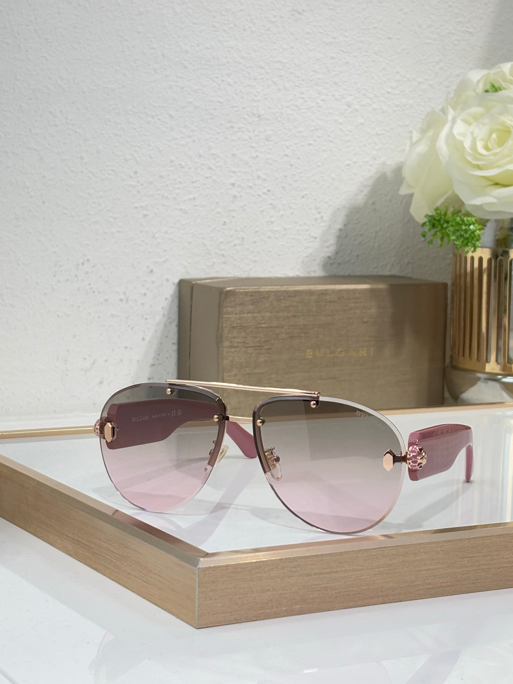 Burgundy sunglasses with pink gradient lenses and gold-tone metal arms