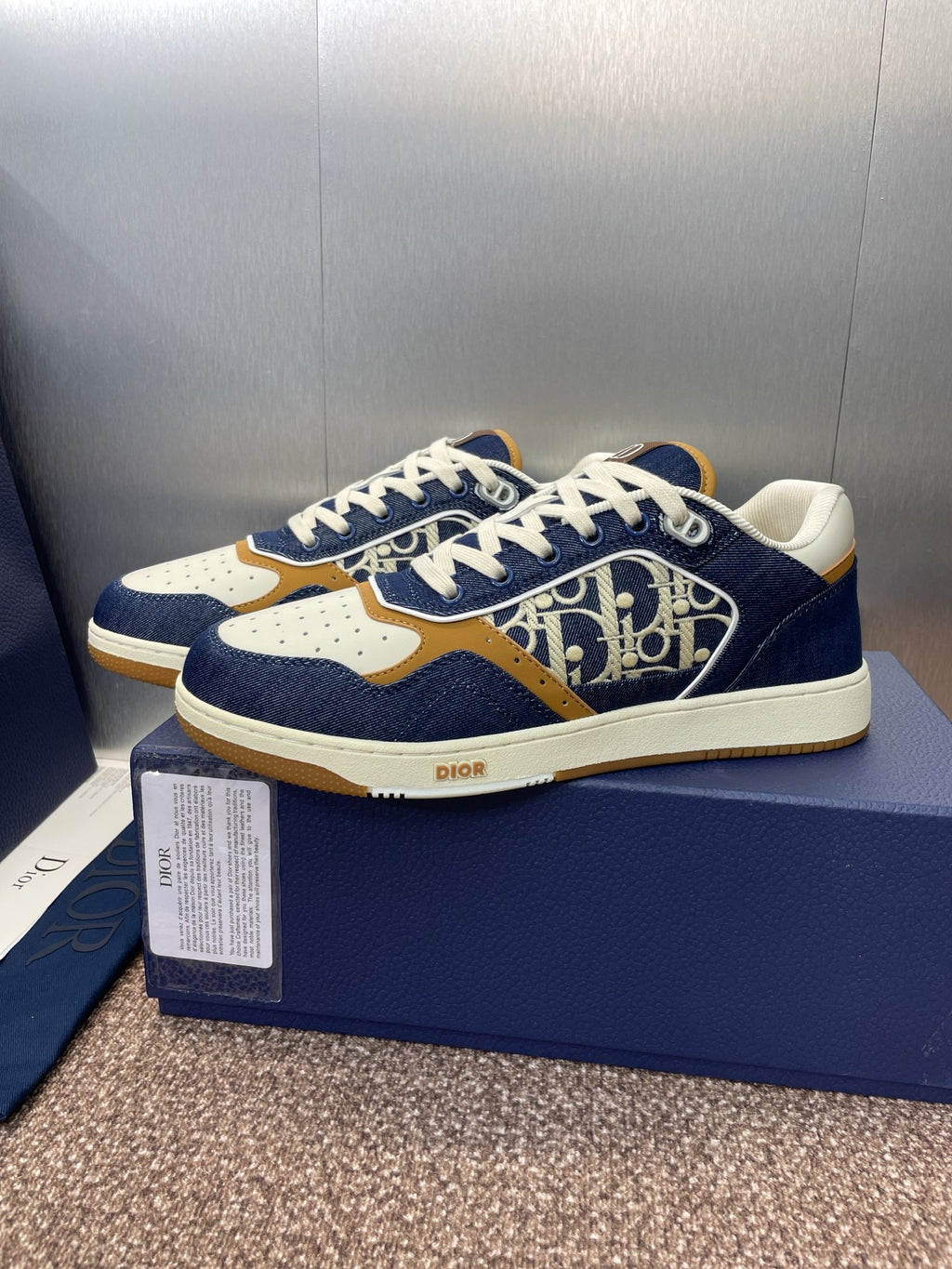 Dior unisex sneakers, navy and white with tan accents and bold logo pattern