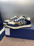 Dior unisex sneakers, navy and white with tan accents and bold logo pattern