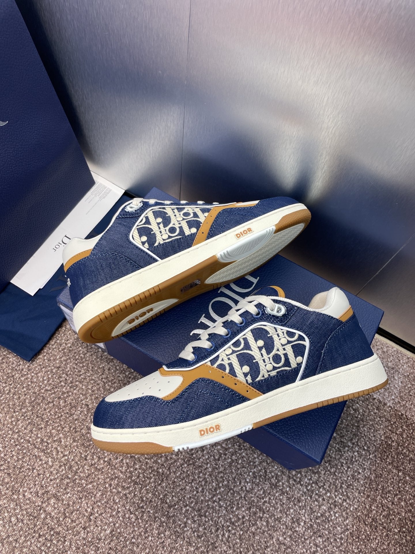 Dior unisex sneakers, navy blue with white sole and tan trim; logo print