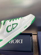 Side view of white low-top sneakers with green CD-style logo and branding strip