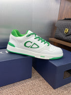 White low-top sneakers with green laces and CD-style side logo on shoe box