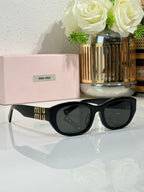 MiuMiu cat-eye sunglasses, side view, black frames with gold Miu Miu logo