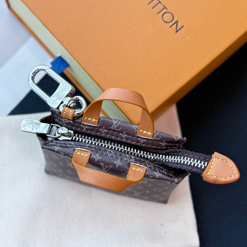 Small Louis Vuitton monogram mini bag with open zipper and tan side strap