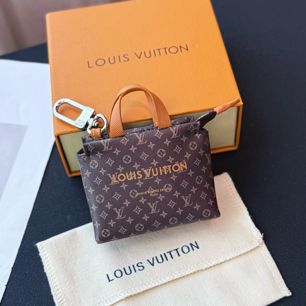 Small Louis Vuitton monogram tote bag with tan top handles and zip closure