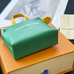 Louis Vuitton small bag in green with yellow handles and logo print on the top panel