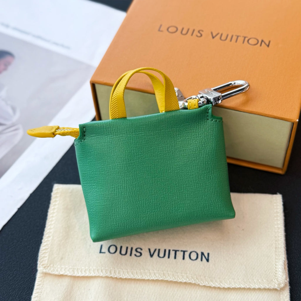 Louis Vuitton small bag in green with yellow strap and silver carabiner clip at side