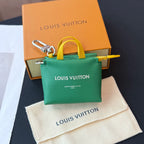 Louis Vuitton small bag with green body, yellow handle, and silver clasp; logo on front