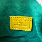 Louis Vuitton patch label on green small bag with yellow trim, “Made in France” text