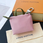 Pink small bag with green handle and silver zip, side view with top opening.