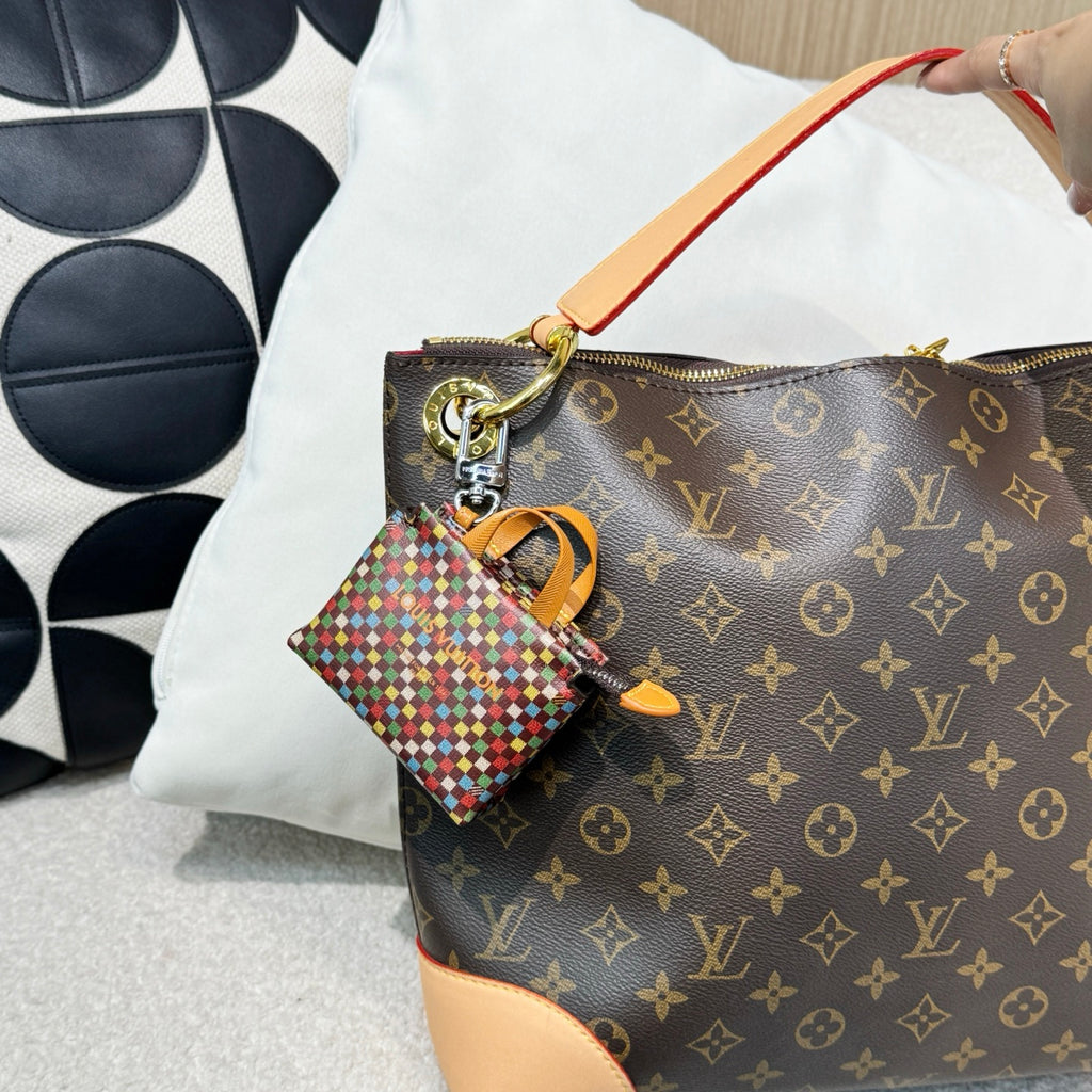 Brown monogram handbag with tan edges and multicolor mini keychain pouch