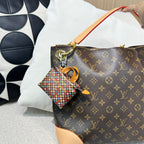 Brown monogram handbag with tan edges and multicolor mini keychain pouch
