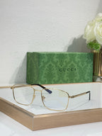 Eyeglasses with gold metal rectangular frame and blue-accent temple hinge