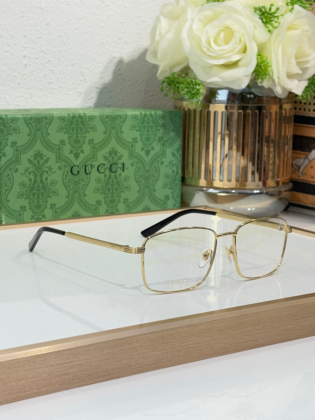 Eyeglasses with gold metal rectangular frame and black temple arms