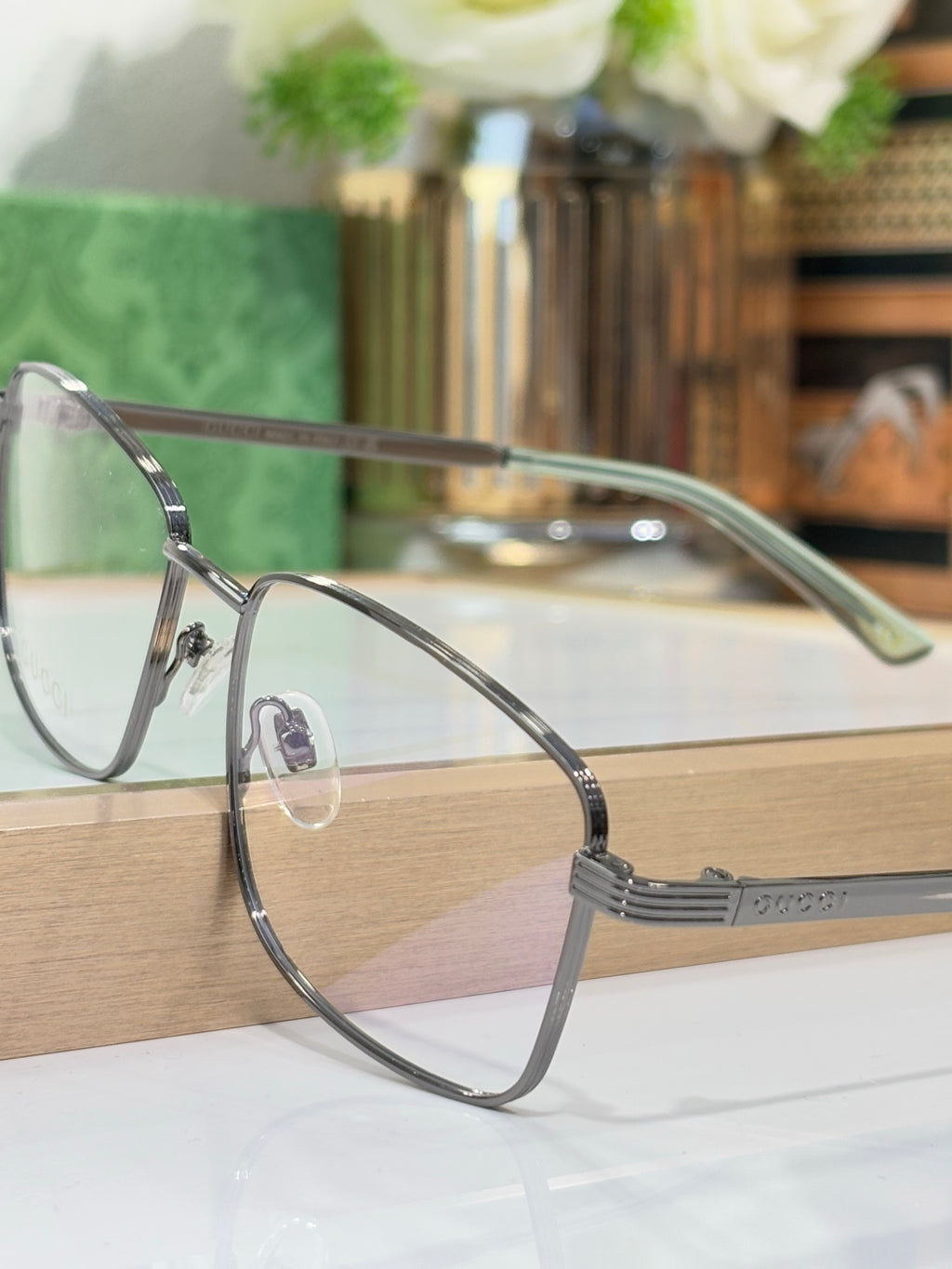 Eyeglasses with dark metal rectangular frame and sculpted temple hinge detail