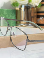 Eyeglasses with dark metal rectangular frame and sculpted temple hinge detail