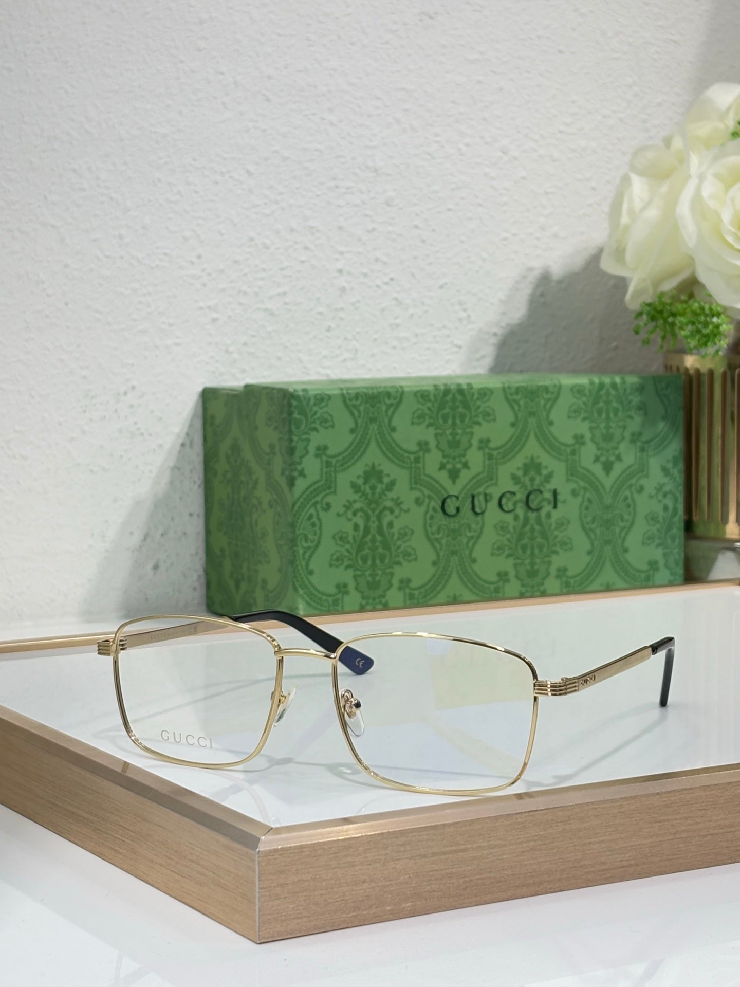 Gucci glasses with gold metal rectangular frame and dark blue temple tips