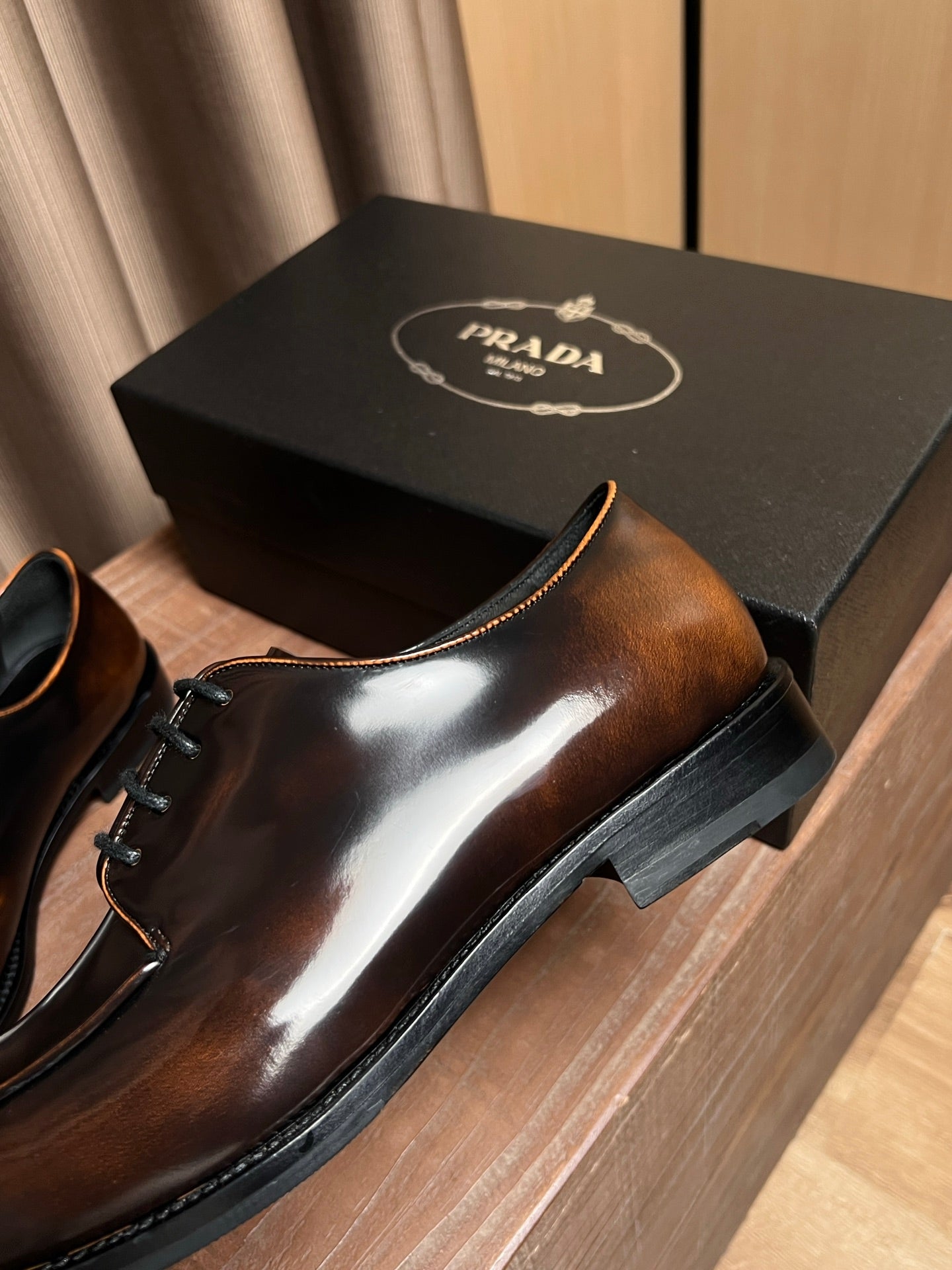 Prada unisex leather derby shoe, dark brown glossy upper with black laces and thick sole