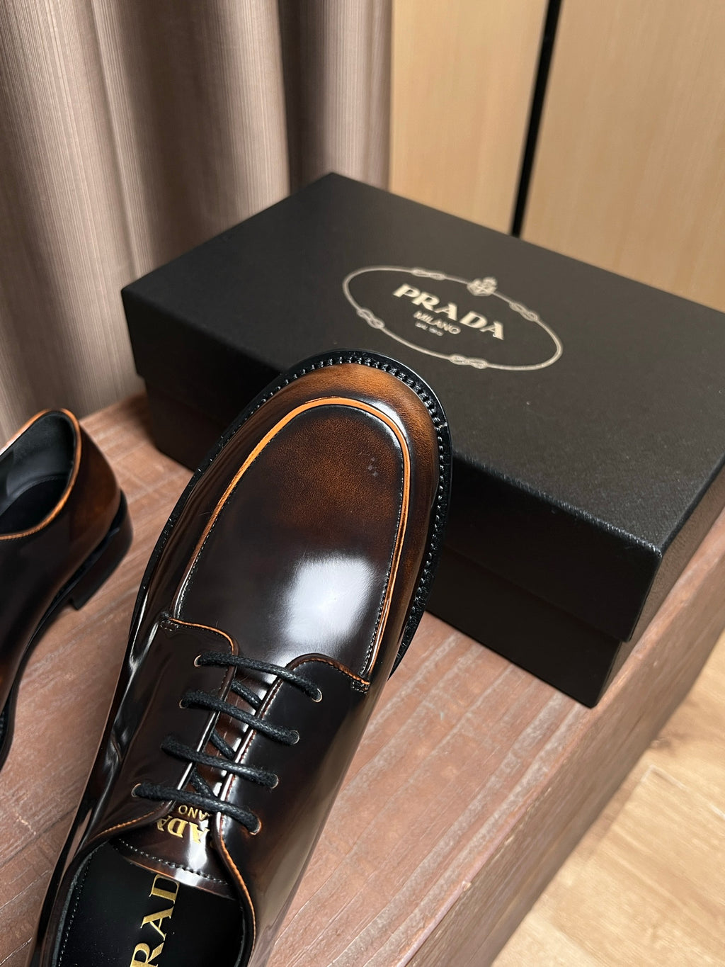 Prada lace-up leather shoes, dark brown, top view showing laces and tan welt