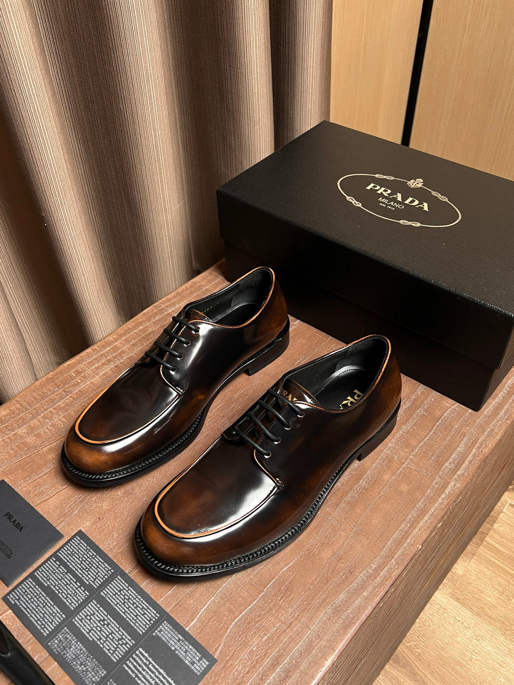 Lace-up leather shoes pair, dark brown finish with black laces and tan stitching