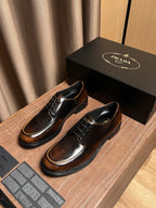 Lace-up leather shoes pair, dark brown finish with black laces and tan stitching