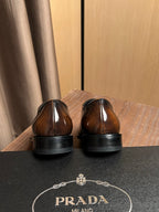 Shoe heels and back view with Prada logo on insole, dark brown leather