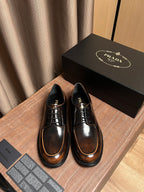Prada lace-up leather shoes, dark brown with tan welt and black laces