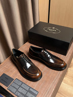 Lace-up leather shoes pair with dark uppers, tan trim, and black rubber sole