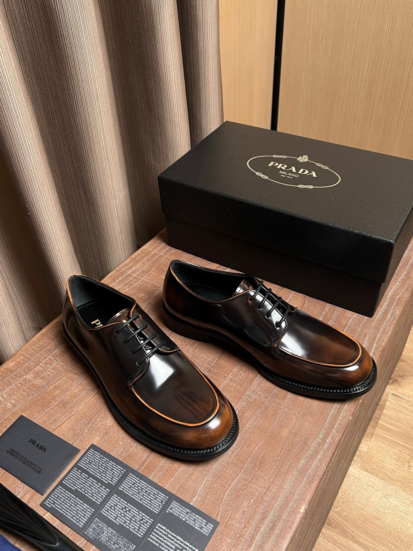 Lace-up leather shoes pair with dark uppers, tan trim, and black rubber sole