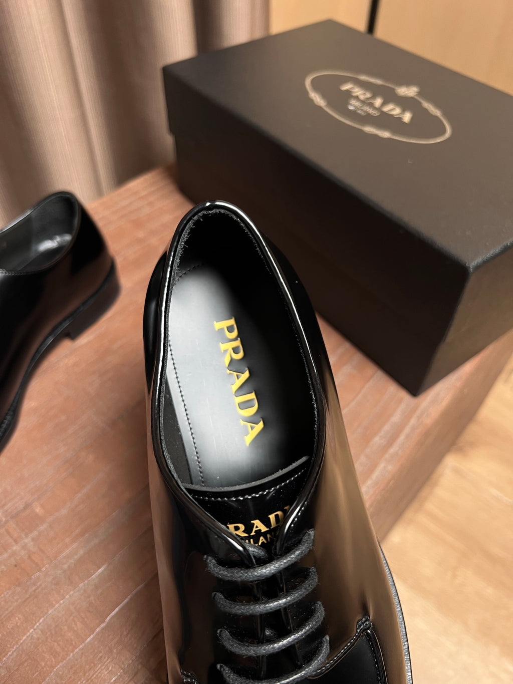 Prada black leather lace-up shoe showing insole with PRADA lettering
