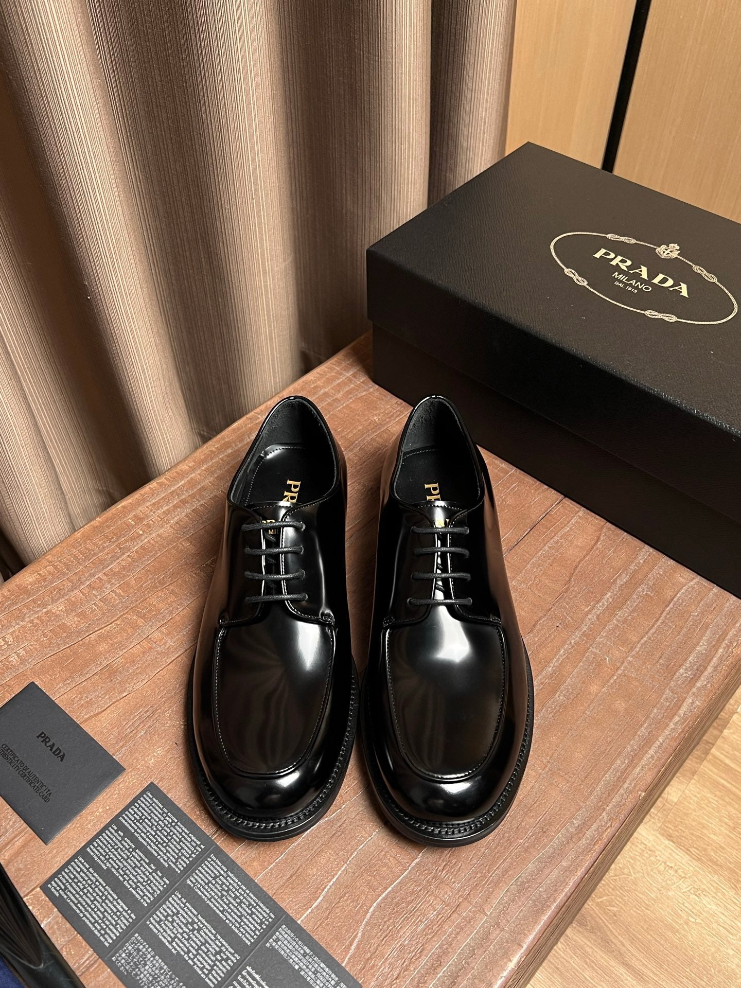 Prada black leather lace-up shoes with glossy finish and round toe