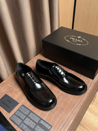 Prada black leather lace-up shoes set with shiny surface and stitched sole