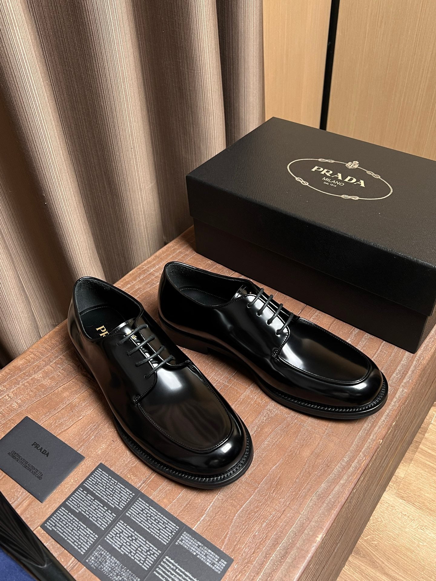Prada black leather lace-up shoes set with shiny surface and stitched sole