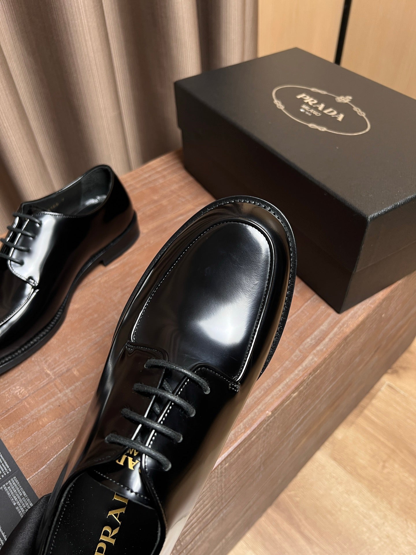 Prada unisex black leather lace-up oxfords, close-up toe and lace area