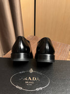 Prada unisex black leather lace-up oxfords, heel and outsole details