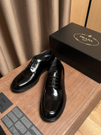 Prada black leather lace-up shoes in two angles, with black laces and glossy uppers