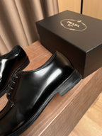 Prada black leather lace-up shoe side view with smooth upper and stacked heel