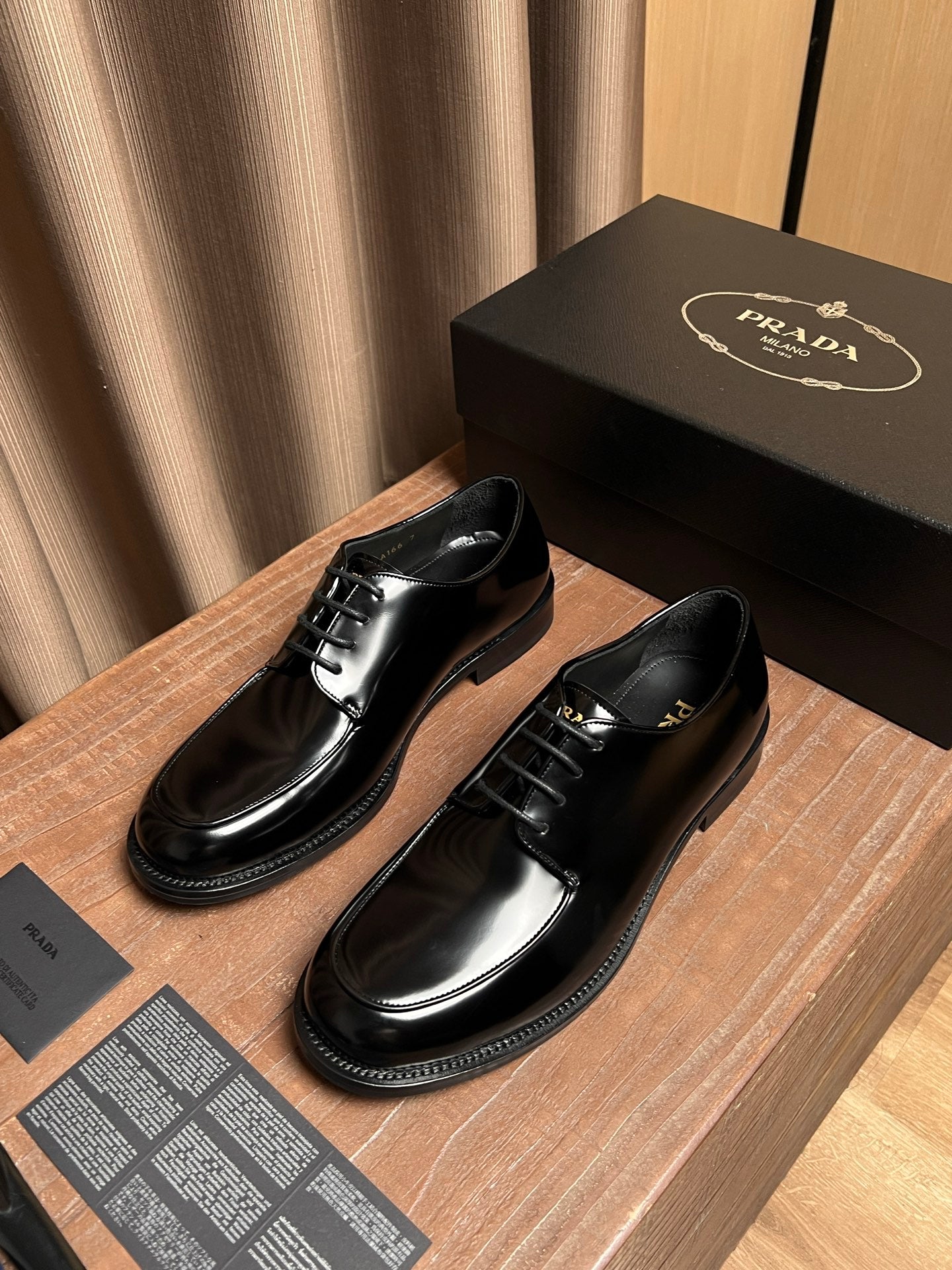 Prada black leather lace-up shoes, front views with lace-up vamp and shine