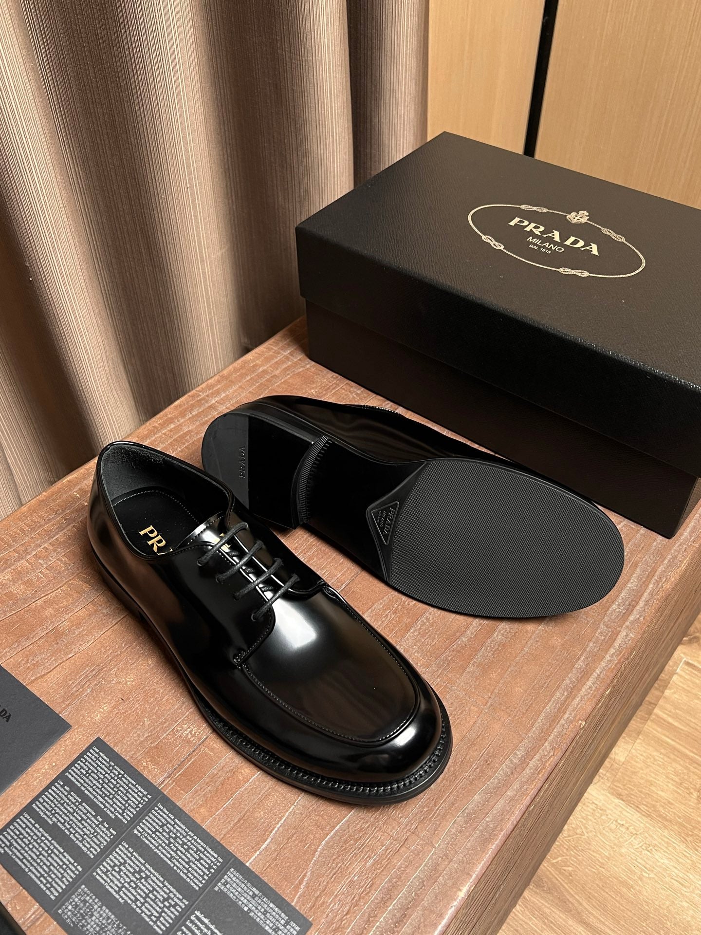 Prada black leather lace-up shoes with matching black sole and lace details