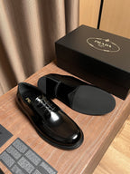 Prada unisex black leather lace-up oxfords, top view of one shoe and insole
